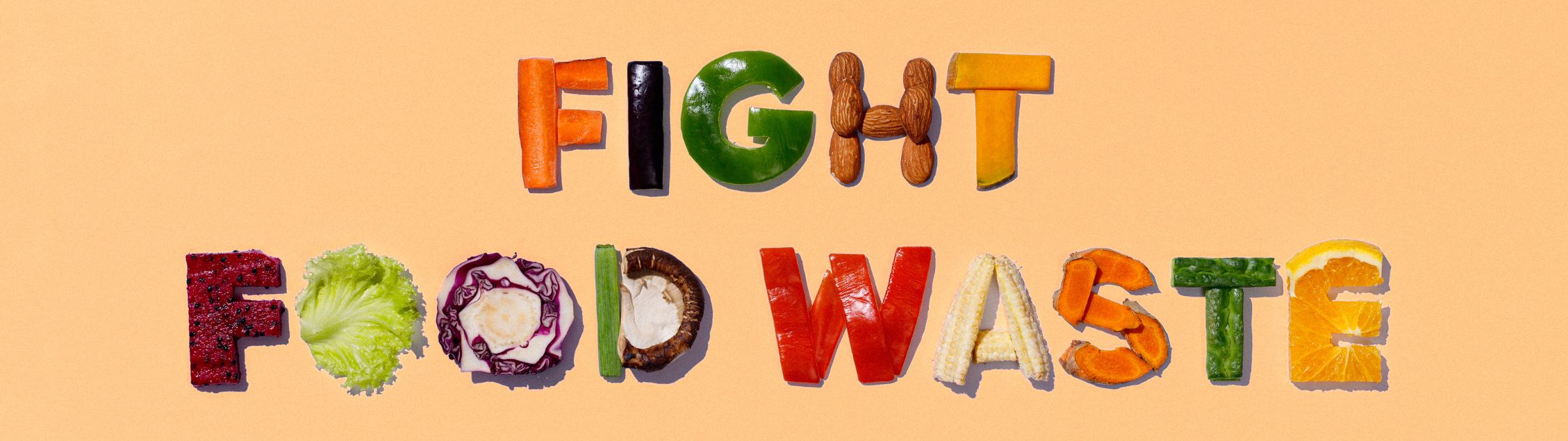 Image of the words Fight Food Waste spelled out using fruits and vegetables